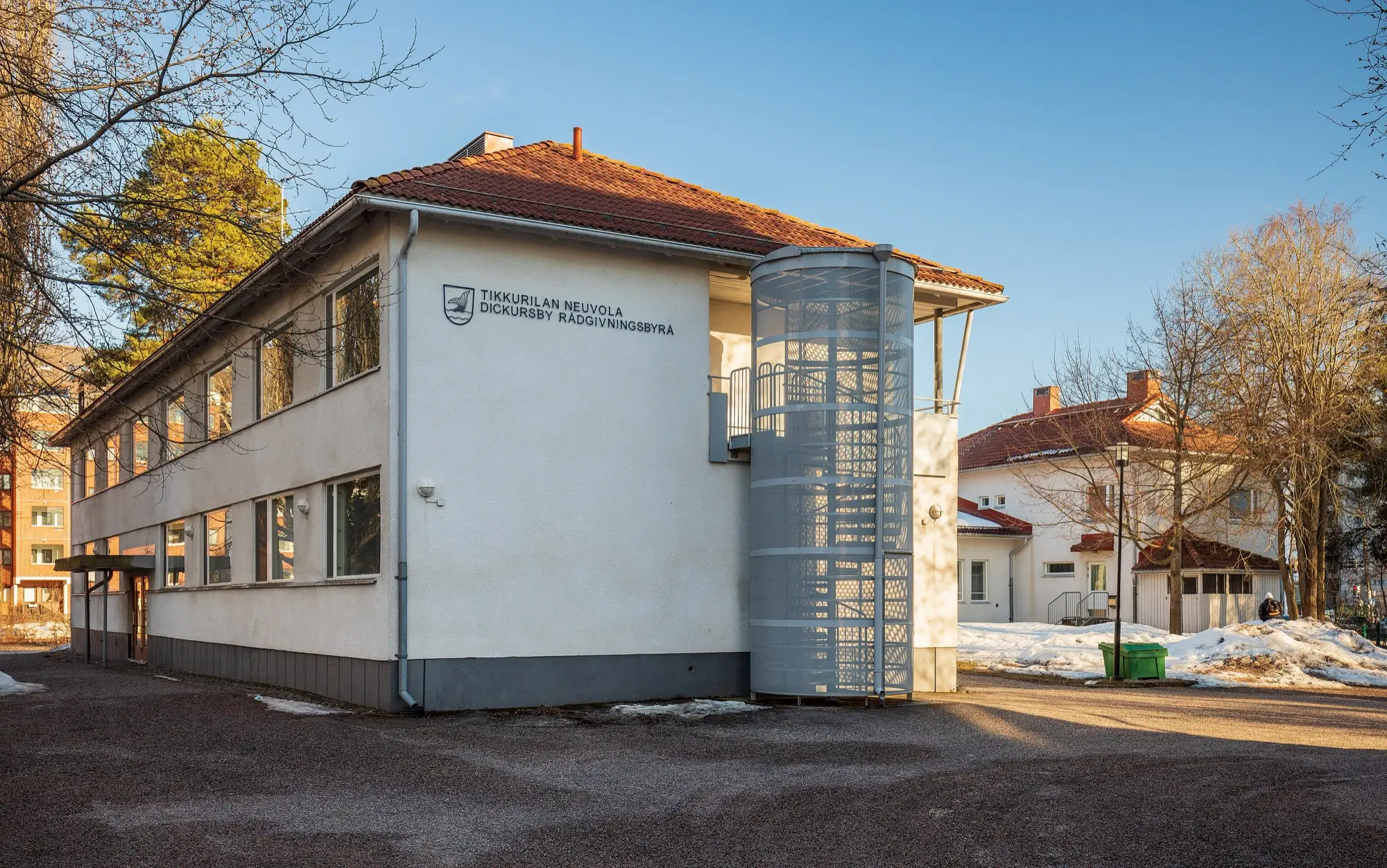 The white two-storey Tikkurila child health clinic building in Vantaa with its Tikkurilan neuvola sign on the wall.