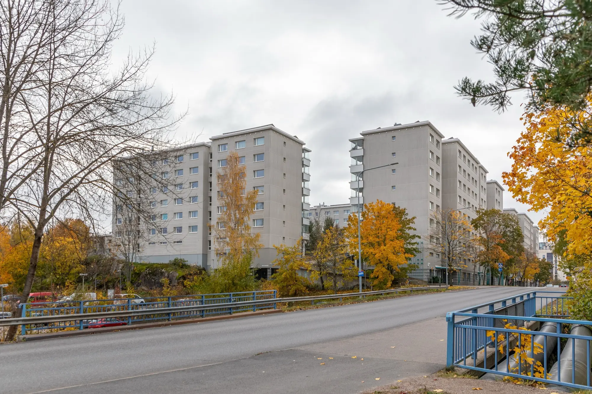 City-owned rental apartment blocks in Pihlajisto, Helsinki, among autumn trees.